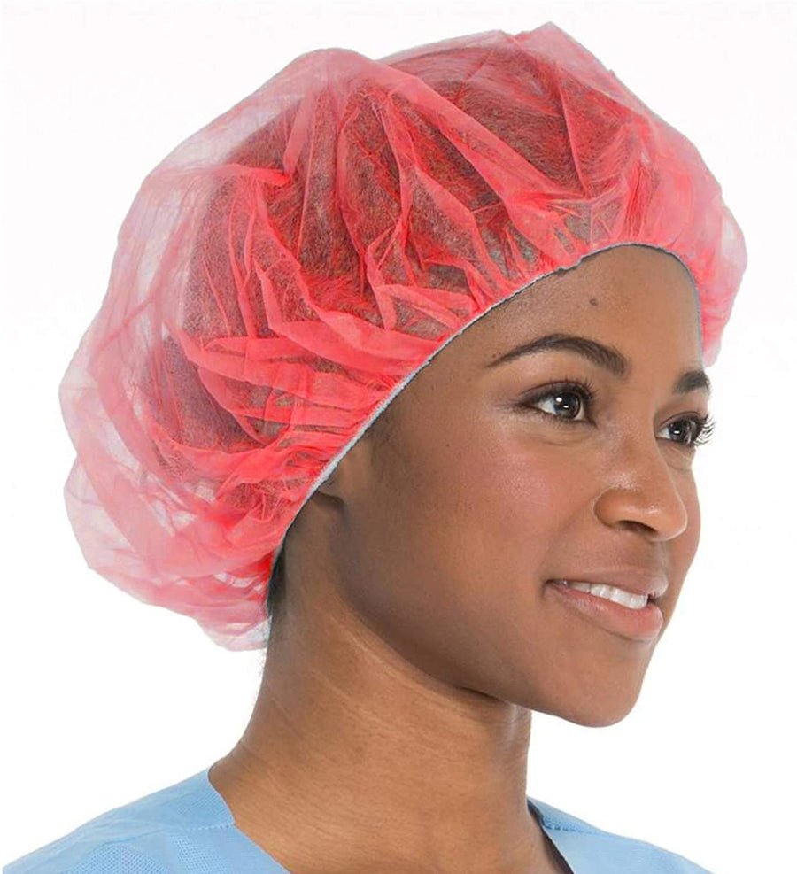 Image of a person wearing a red bouffant cap made from spunbonded polypropylene. The cap is latex-free and provides reliable protection. Ideal for medical, food service, and manufacturing industries.