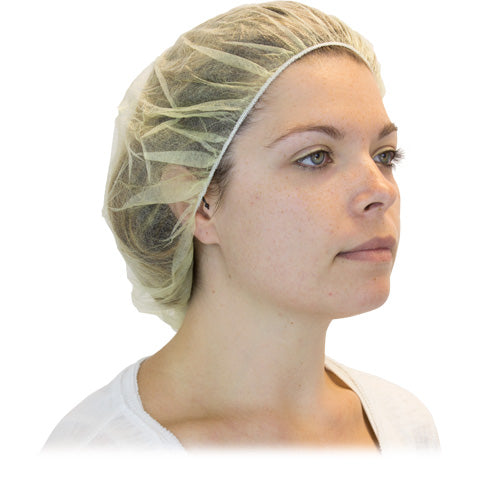 Image of a person wearing a yellow bouffant cap made from spunbonded polypropylene. The cap is latex-free and provides reliable protection. Ideal for medical, food service, and manufacturing industries.