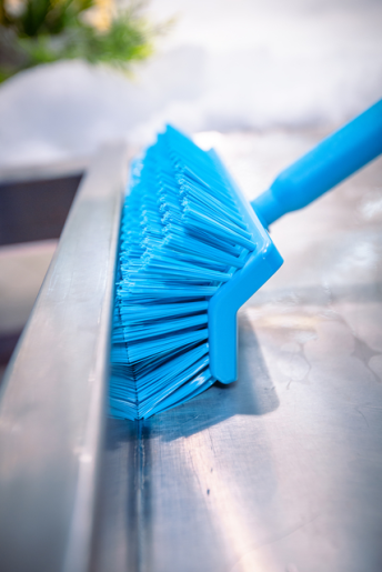 10" Medium Scrub Brush - Durable and versatile cleaning tool with medium-soft bristles. Suitable for various surfaces. Available in 12 colors to complement any cleaning setup. Remco 10" Medium Scrub Brush broom from Techniclean blue