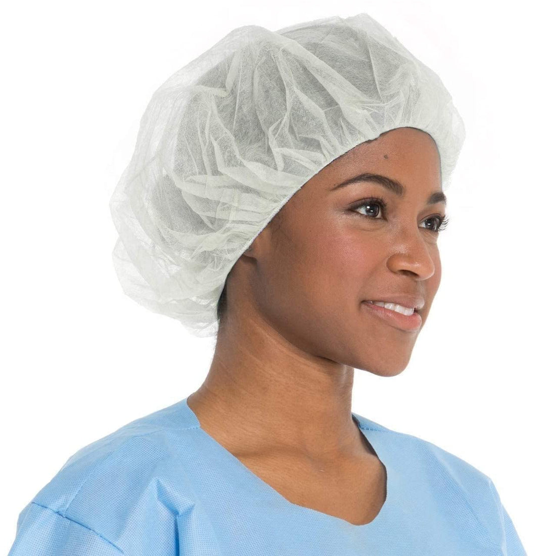 Image of a person wearing a white bouffant cap made from spunbonded polypropylene. The cap is latex-free and provides reliable protection. Ideal for medical, food service, and manufacturing industries.